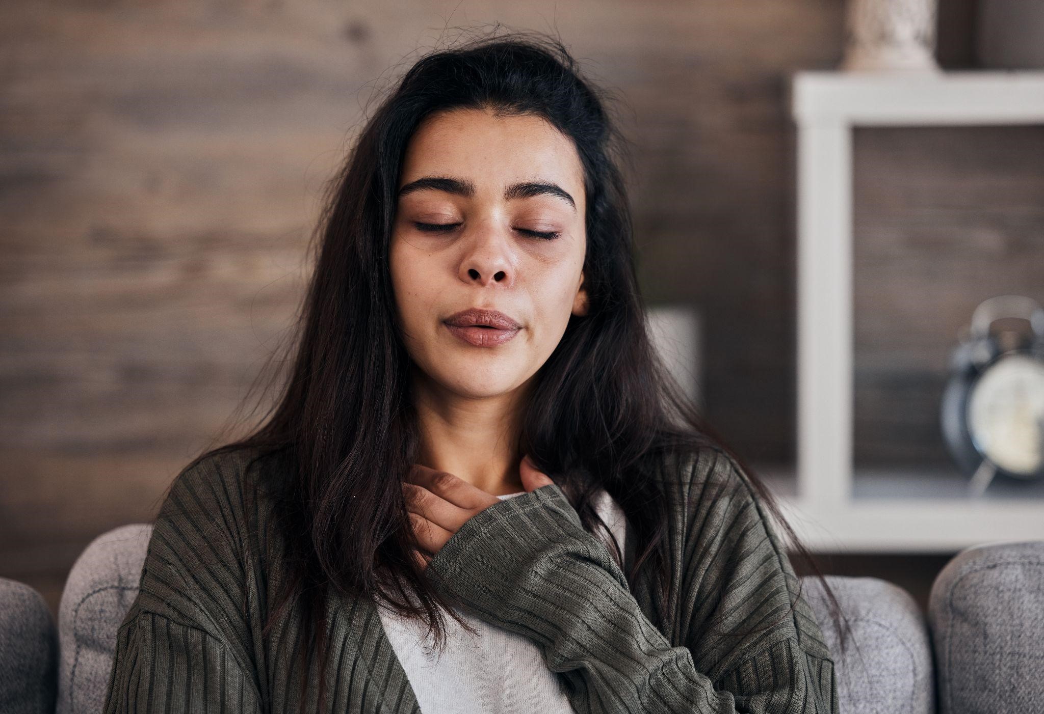 anxious woman taking a deep breat